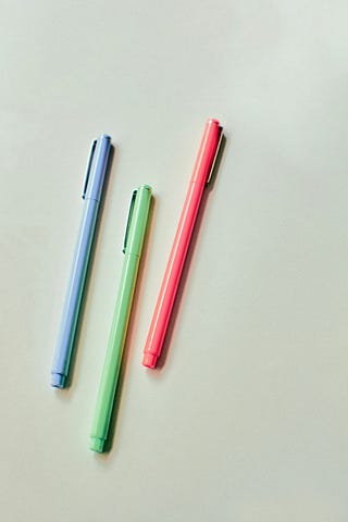 three different coloured pens