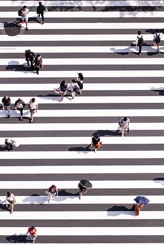 A busy life as seen by people crossing the street.