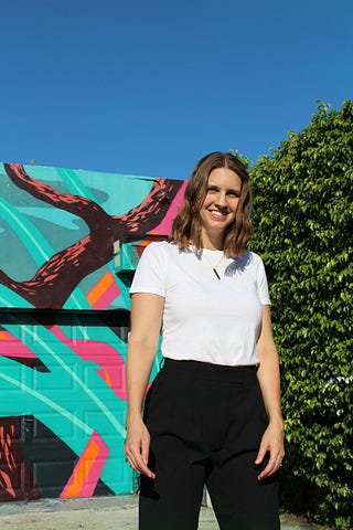 Nicole standing in front of street art