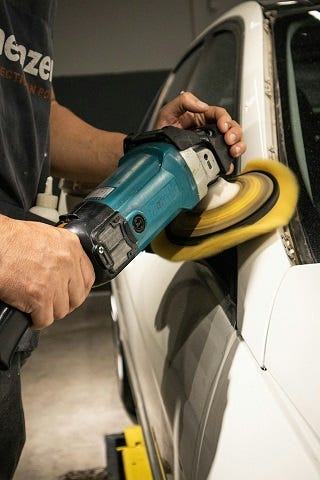 Polishing a car using a machine polisher