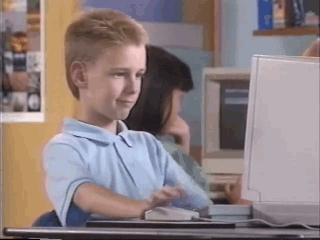Gif of a young kid working with an old compter reacting with a thumb up