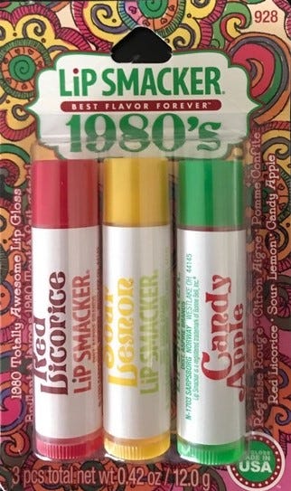 An 80’s Lip Smacker package with three of the glosses inside.