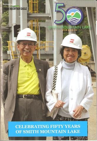 Magazine cover shows a smiling couple wearing white construction hats.