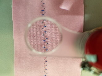 A zig-zag stitch of conductive thread to make a textile stretch sensor