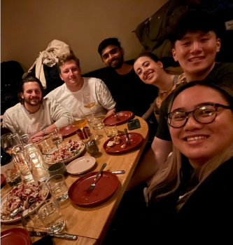 Members of the SDR team smile and gather for dinner in NYC.