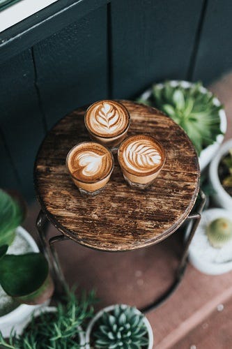 Three cups of coffee on a stool