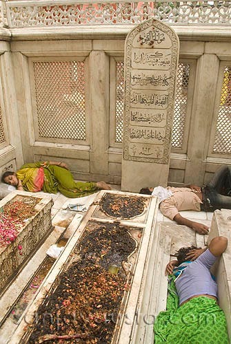 Image of Jahanara Begum’s Tomb in sorry state with people sleeping around it.