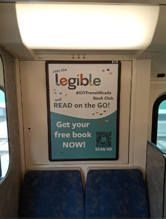 Photo of a sign on a train advertising Legible with text that reads, “Get your free book now!” with a QR code.