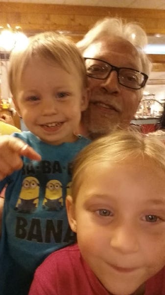 Smiling for the camera with his grandkids!