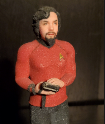 An image of a glass 3d printed self-portrait of myself as a star trek officer.