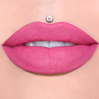 A semi-opened mouth with Jeffree Star’s liquid lipstick in the color Romeo (pink) on the lips.