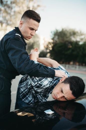 Police officer handcuffing suspect