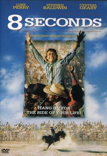 Movie poster for “Eight Seconds” a man on other men’s shoulders with his arms raised. Striped shirt and a smile.