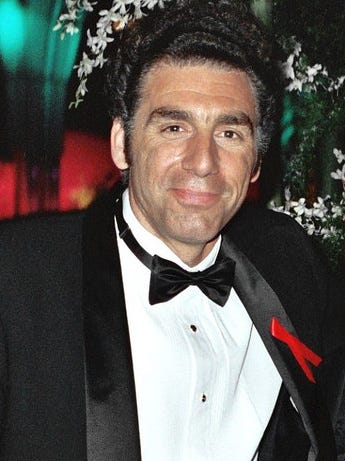 Actor Michael Richards attending an award dinner, dressed in a tuxedo.