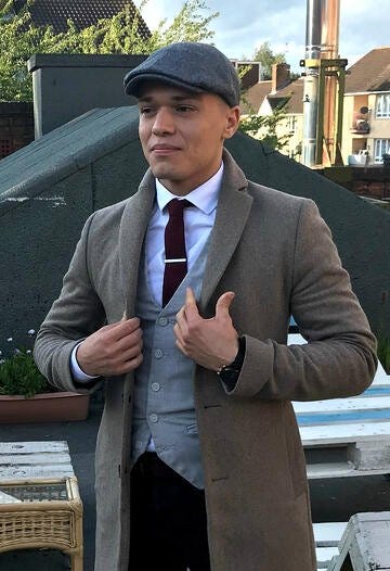 Matěj poses in a Peaky Blinders themed outfit