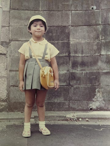 Author posing in her kindergarten uniform in Japan.