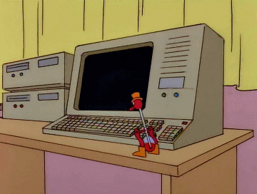 A toy bird hitting a key on a keyboard.