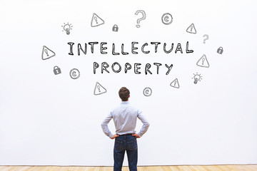 A man looking at the words “Intellectual Property”