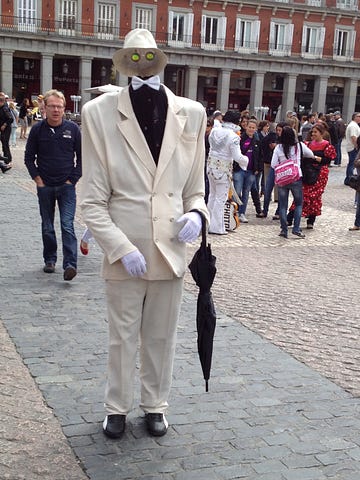 Photo of tall man in suit, but with an invisible head with visible eyes in Spain.