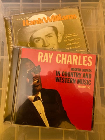 Authors photo of the cover of their copies of the CD albums The Best of Hank Williams and Modern Sounds in Country and Western Music Volumes 1&2