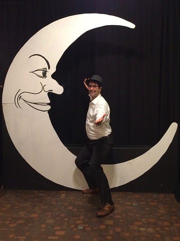 Author ready to dance in front of a carve-out design of the Moon.