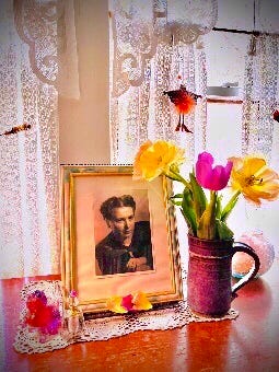 A portrait of my mother on my desk with the tulips and petals.