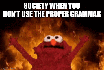 A GIF meme where Elmo is standing with his arms outstretched above his head as if to embrace chaos while there is a burning fire in the background.