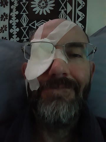 Man with homemade eyepatch, smiling