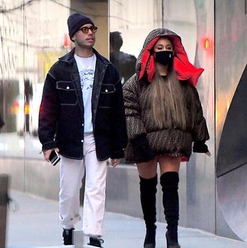 Ariana Grande and friend walking in the city, she is wearing a black cloth mask