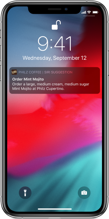 A Lock screen showing a Siri suggestion “Order Mint Mojito.” Below the suggestion appear additional details: “Order a large, medium cream, medium sugar Mint Mojito at Philz Cupertino.”