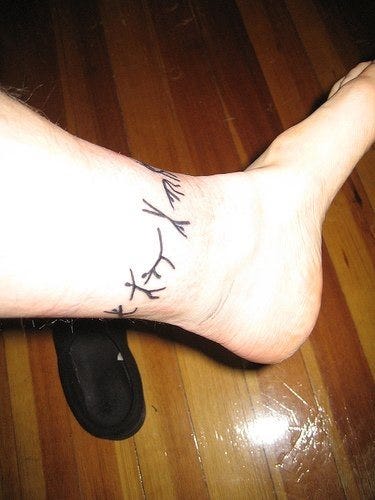 1084 ankle tattoo