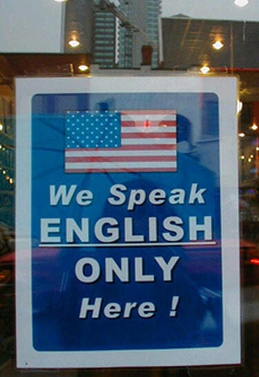We speak English only here Sign on a door