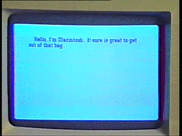 Picture of the original Macintosh screen from 1984 saying “Hello. I’m Macintosh. It sure is great to get out of that bag.”