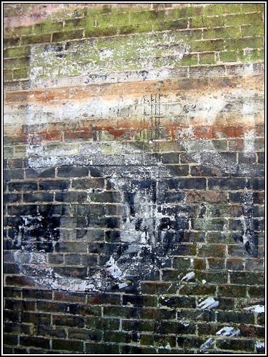 Faded paint on old bricks reading “5 cents” on a building in Eureka Springs, Arkansas.