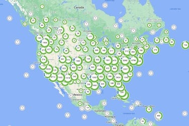 A tiny map showing the US and Canada that is covered with EV charging facilities