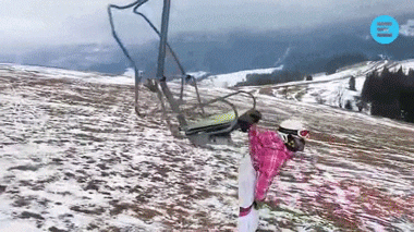 Ladies handed by her backpack to a moving chair lift
