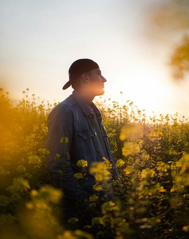 A man standing amidst flowers