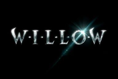 The logo for Willow on Disney+, showing silver letters over a black background, with a shining effect over the O.