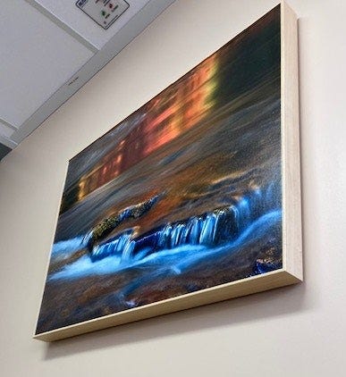 Image of a painting of a river flowing over a rock.