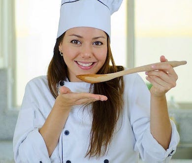 Female chef tasting soup