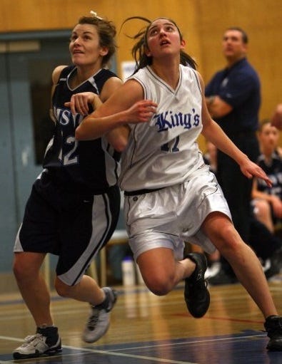 Two women boxing out during a basketball game