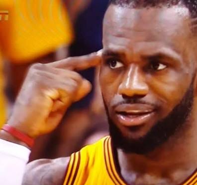 Lebron James pointing to his head asking if his teammate has sense