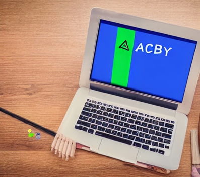 A computer with a green and blue screen showing the letters ACBY. The computer is on a table.