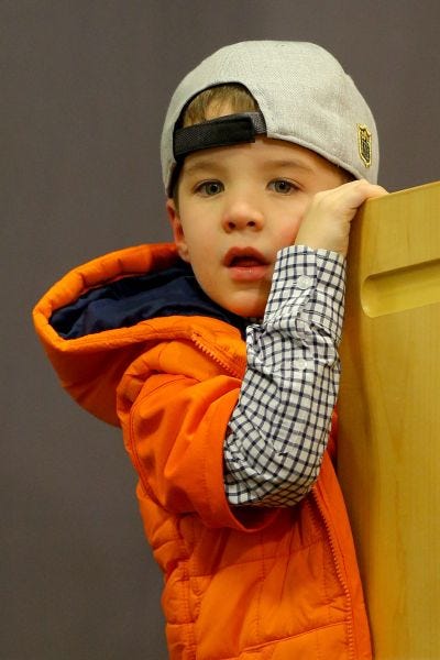 Peyton Manning's son, Marshall, looks on during a post game press conference.