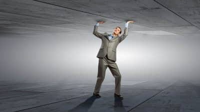Man holding up ceiling analogous to overcoming adversity