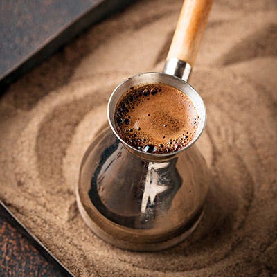 Traditional Greek coffee brewed in hot sand