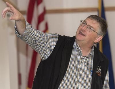 Aquatic veterinarian Tim Miller-Morgan gestures while giving a presentation.