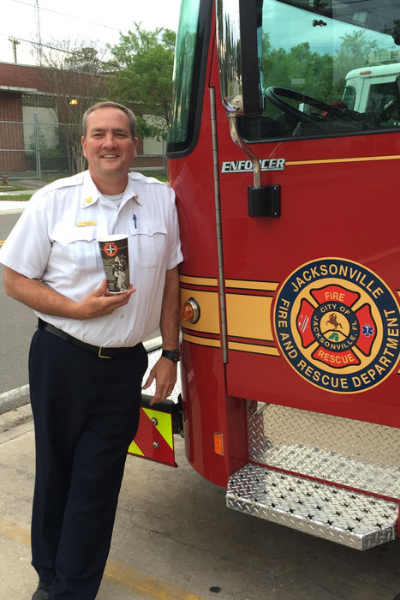 Jacksonville Fire & Rescue Battalion Chief Brady Rigdon with his Firehouse Subs Hero Cup.