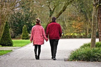 Two person walking on the park