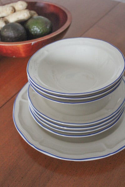 Stacked white dish set with navy blue trim